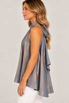 Ainsley Top by Fate in metallic silver-gray with a sleeveless halter cut and draped flared silhouette, side view. Style# FT25816