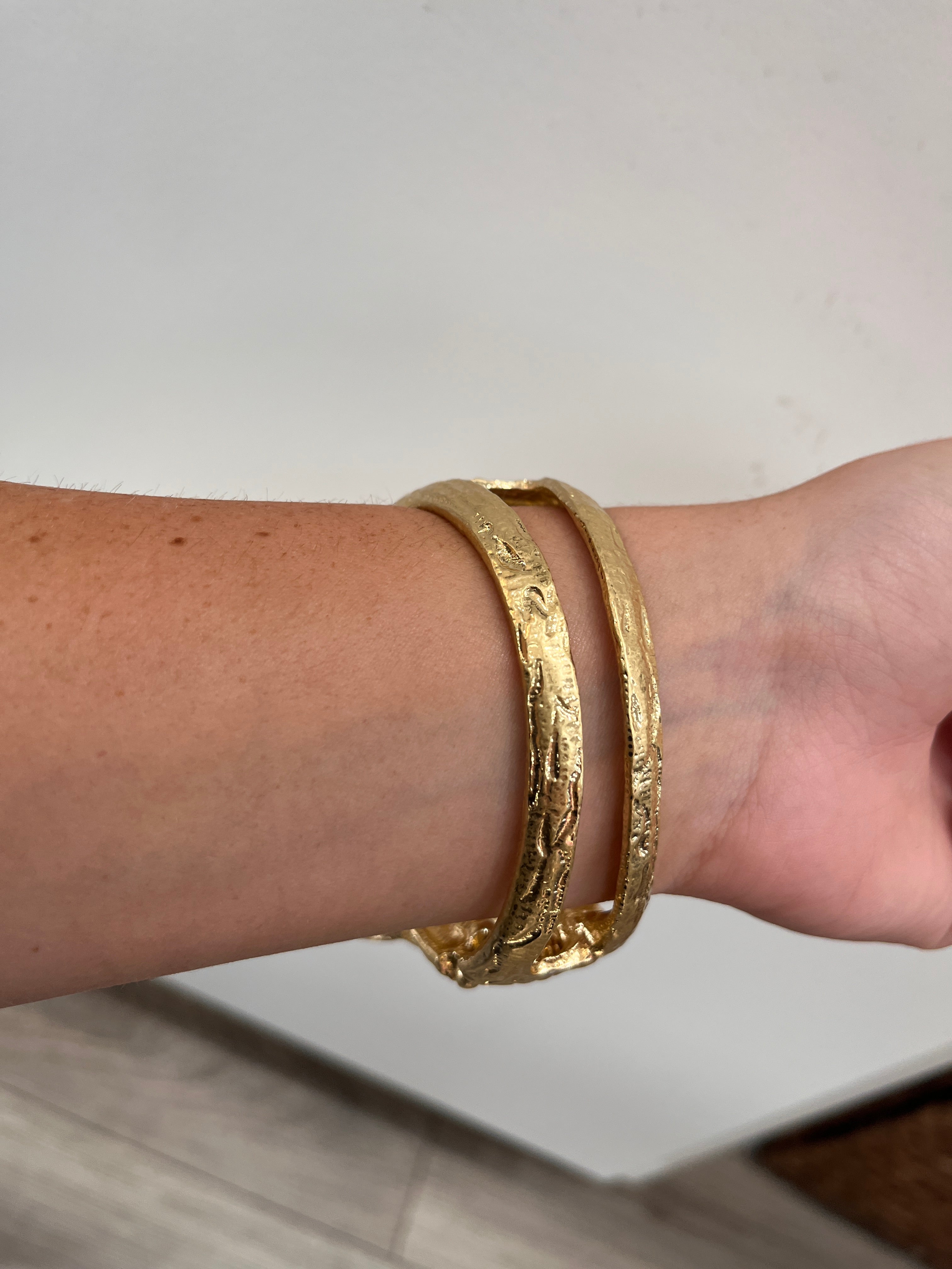 textured gold cuff bracelet with rose shaped flower