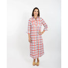 Woman wearing a red and white checkered dress on a white background