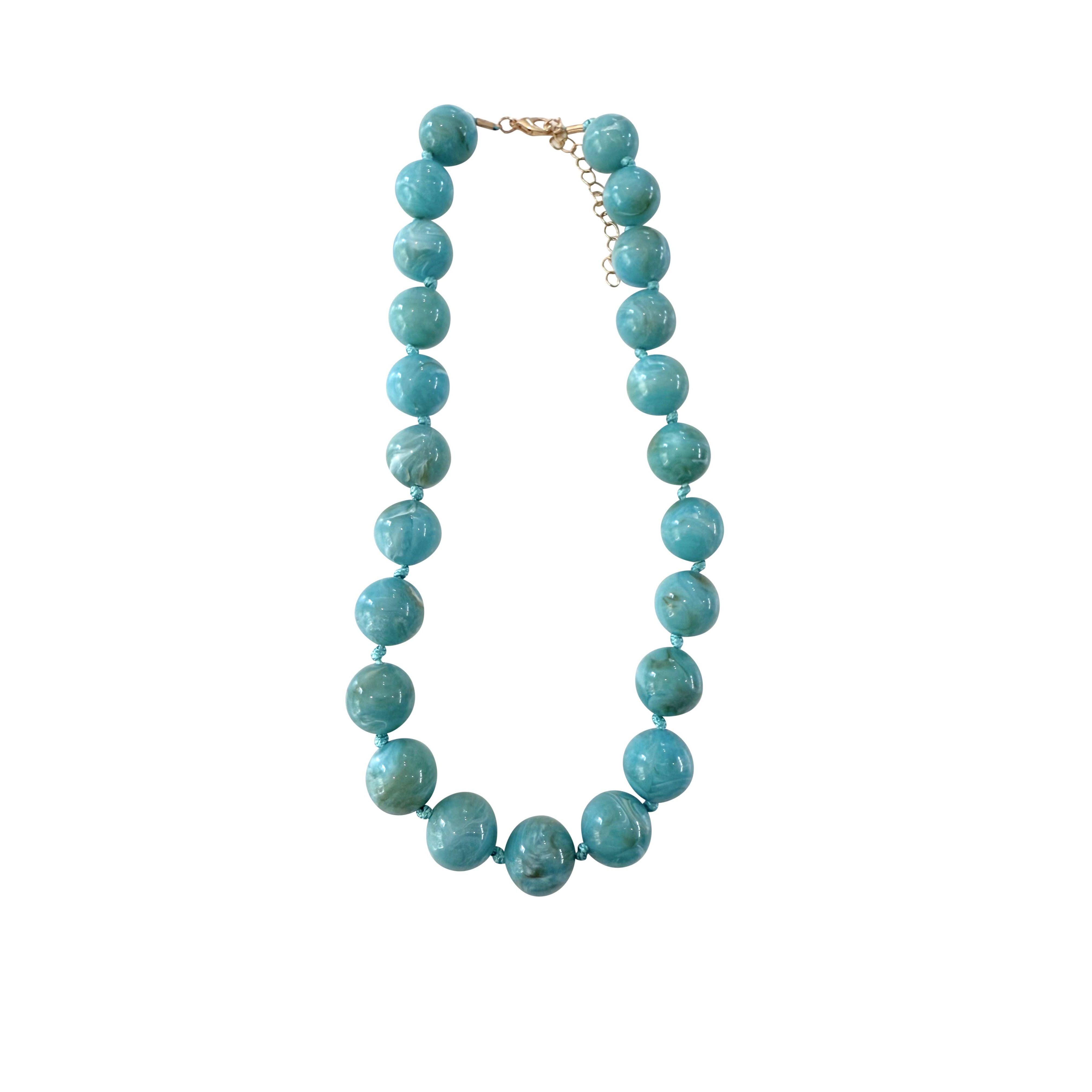Gemelli Mabry chunky beaded necklace featuring vibrant turquoise beads and a stylish jewelry design.