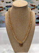 Harvest Pendant Beaded Necklace in Toasted Almond by Smith and Co. Design — cream glass beads with gold spacers and square amber enamel pendant 

