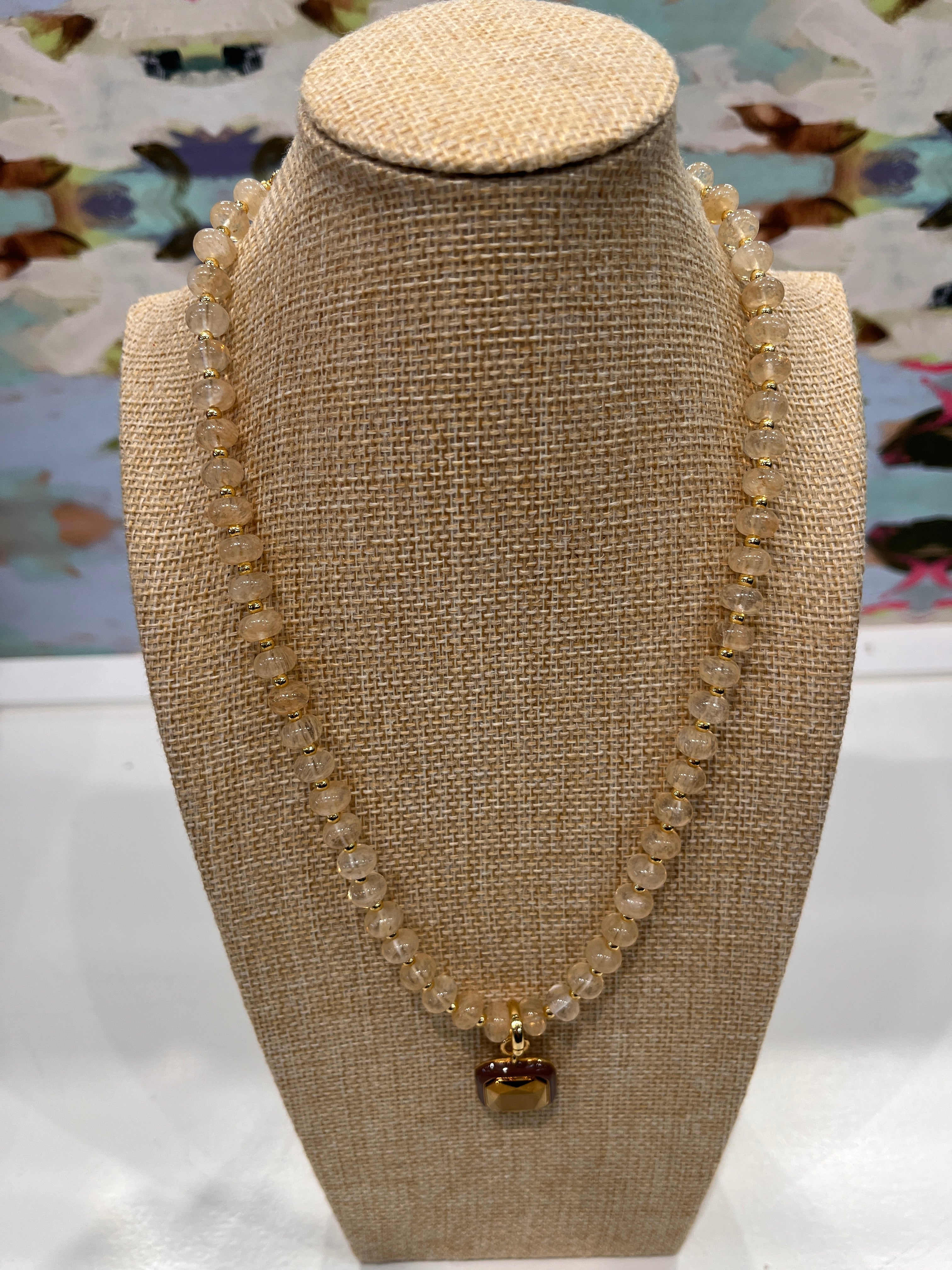 Harvest Pendant Beaded Necklace in Toasted Almond by Smith and Co. Design — cream glass beads with gold spacers and square amber enamel pendant 


