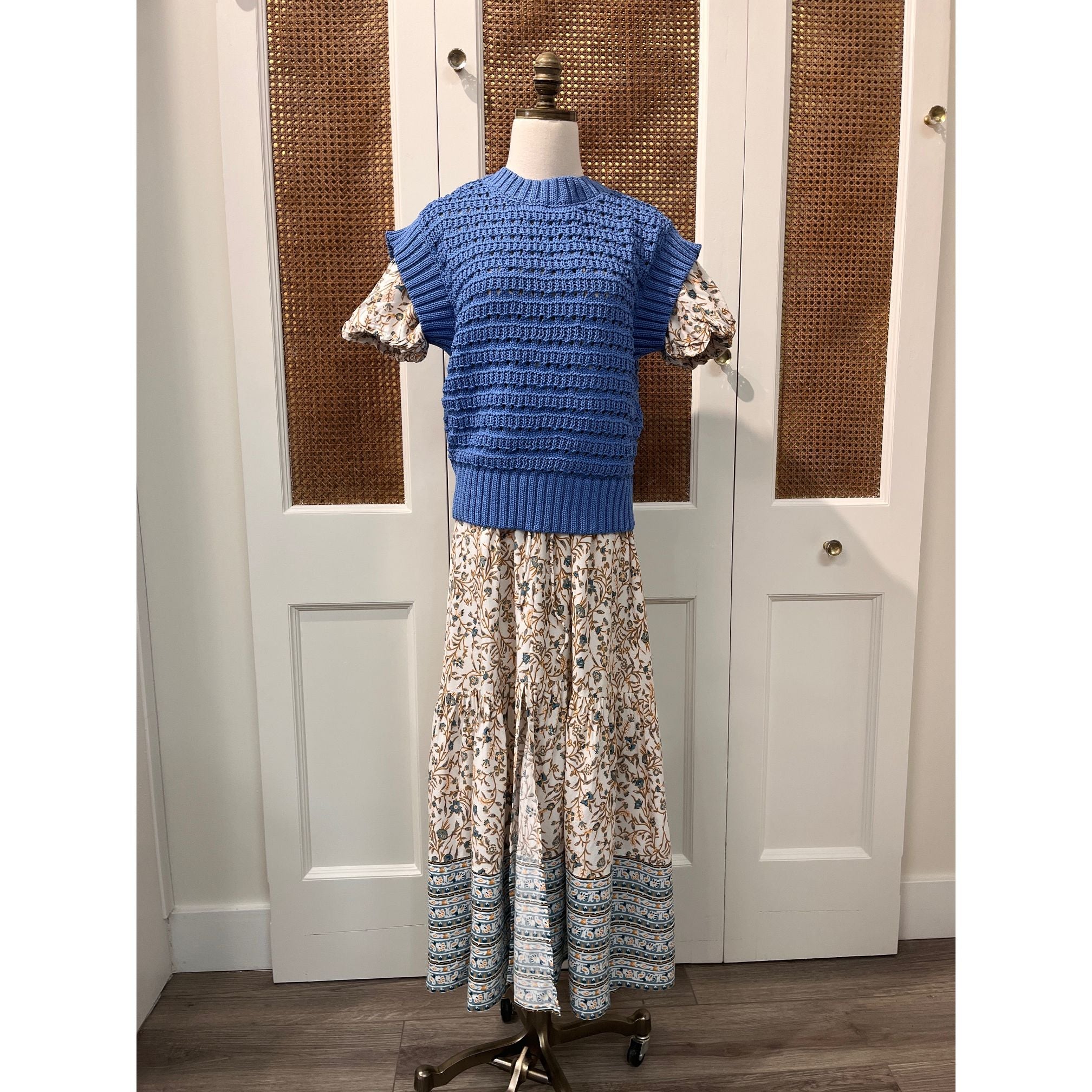 Elan Carina Dress hanging on a hanger, featuring a flowy fabric and elegant design, perfect for casual or semi-formal occasions.