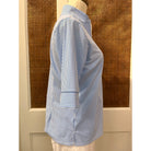 Jude Connally Juliet Top in pinstripe periwinkle with long sleeves and a relaxed fit, displayed on a hanger.