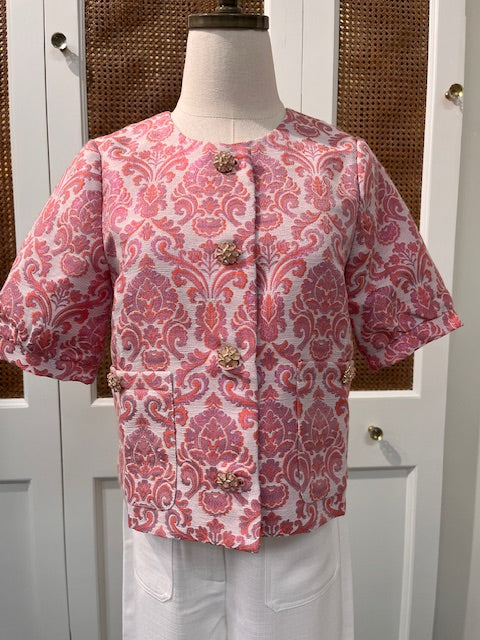 JADE Taylor jacket top displayed on a hanger, showcasing its stylish design and fabric texture.