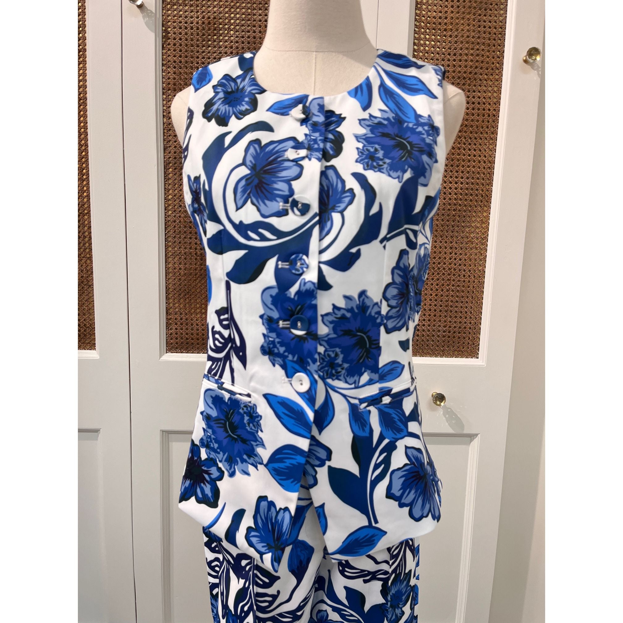 JADE Gladys top, stylish women's sleeveless blouse in vibrant fabric, displayed on a hanger.