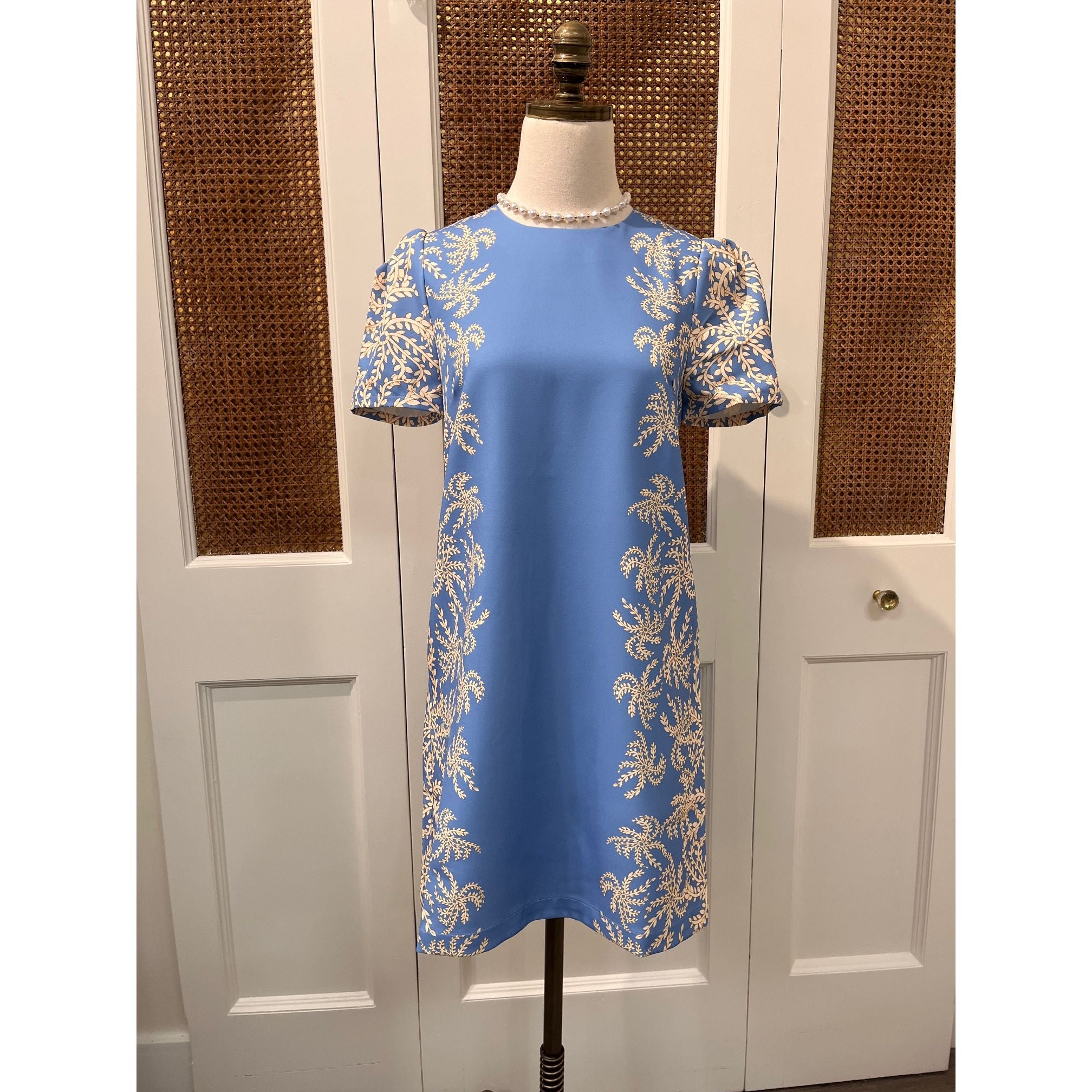JADE Vera dress displayed on a hanger, featuring a flowing fabric and stylish design ideal for casual or formal wear.