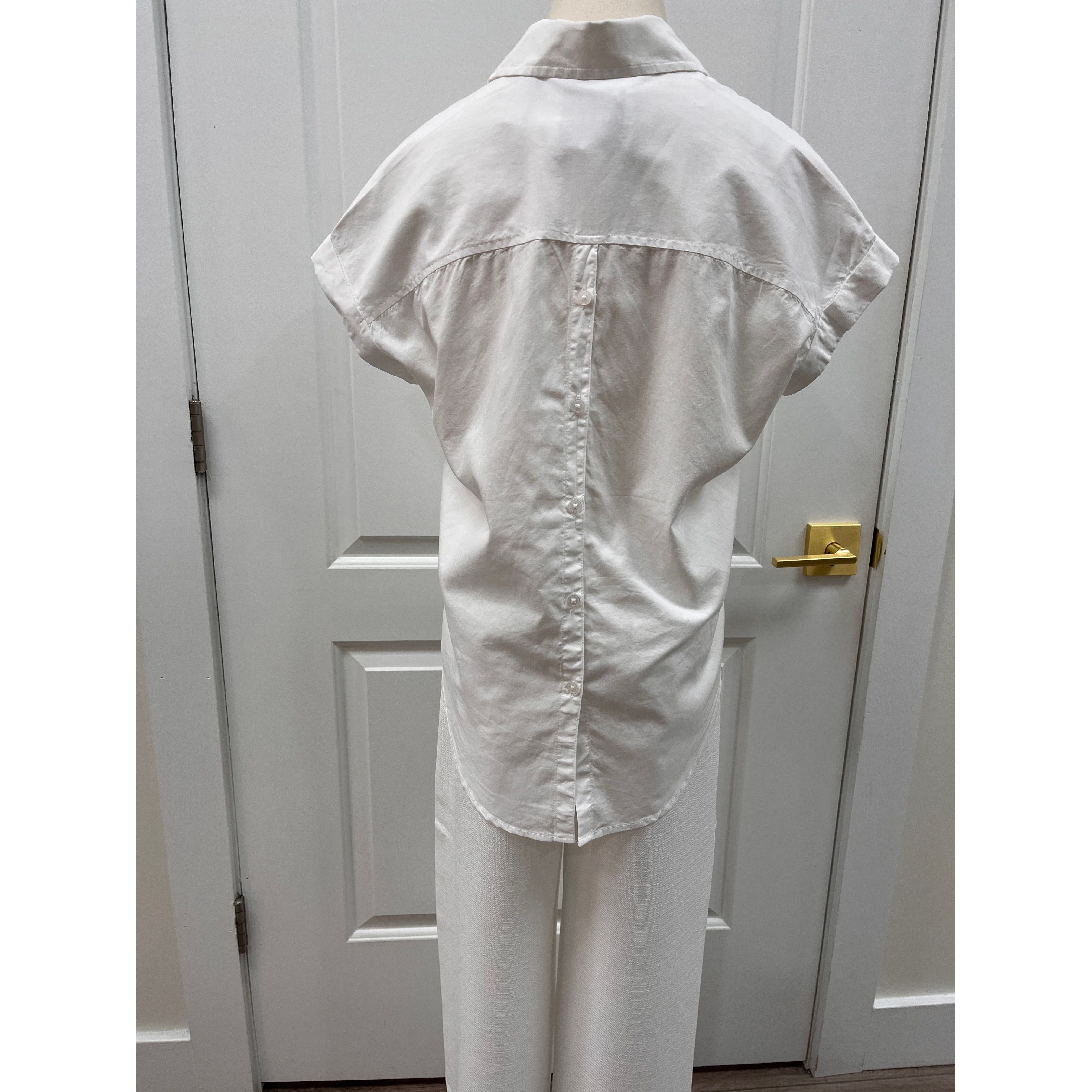 Lola River Amara Top displayed on a hanger, featuring a stylish design in soft fabric with a V-neck and short sleeves.