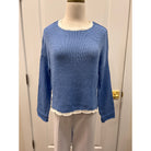 Wooden Ships Kyla sweater top hanging on a display with a soft knit texture and neutral color.