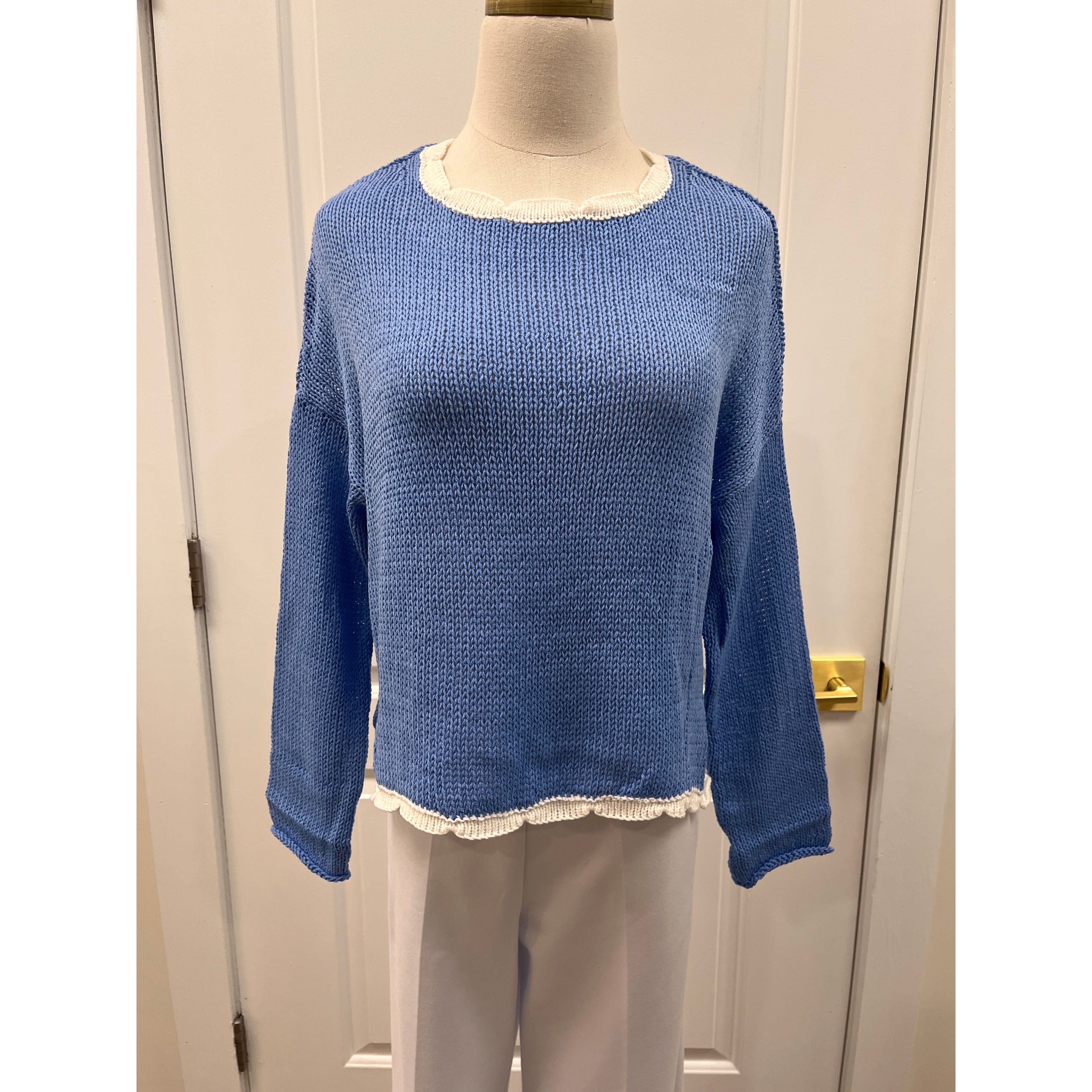 Wooden Ships Kyla sweater top hanging on a display with a soft knit texture and neutral color.