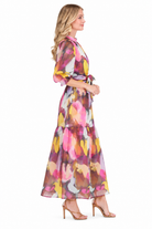 Ellis Dress by Jade in Harvest Brush, side view showing puff sleeves, waist sash, and tiered maxi skirt