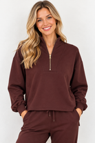 Edie Top by Molly Bracken in chocolate brown with gold-tone half zip, stand collar, and long sleeves, front view