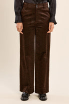 Finley Trousers by Molly Bracken, close-up of brown satin animal print with two-button high waist and front fly