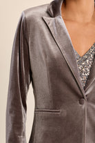 gray velvet blazer with notched lapels and a single front button