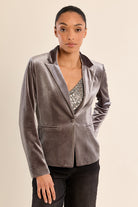 gray velvet blazer with notched lapels and a single front button