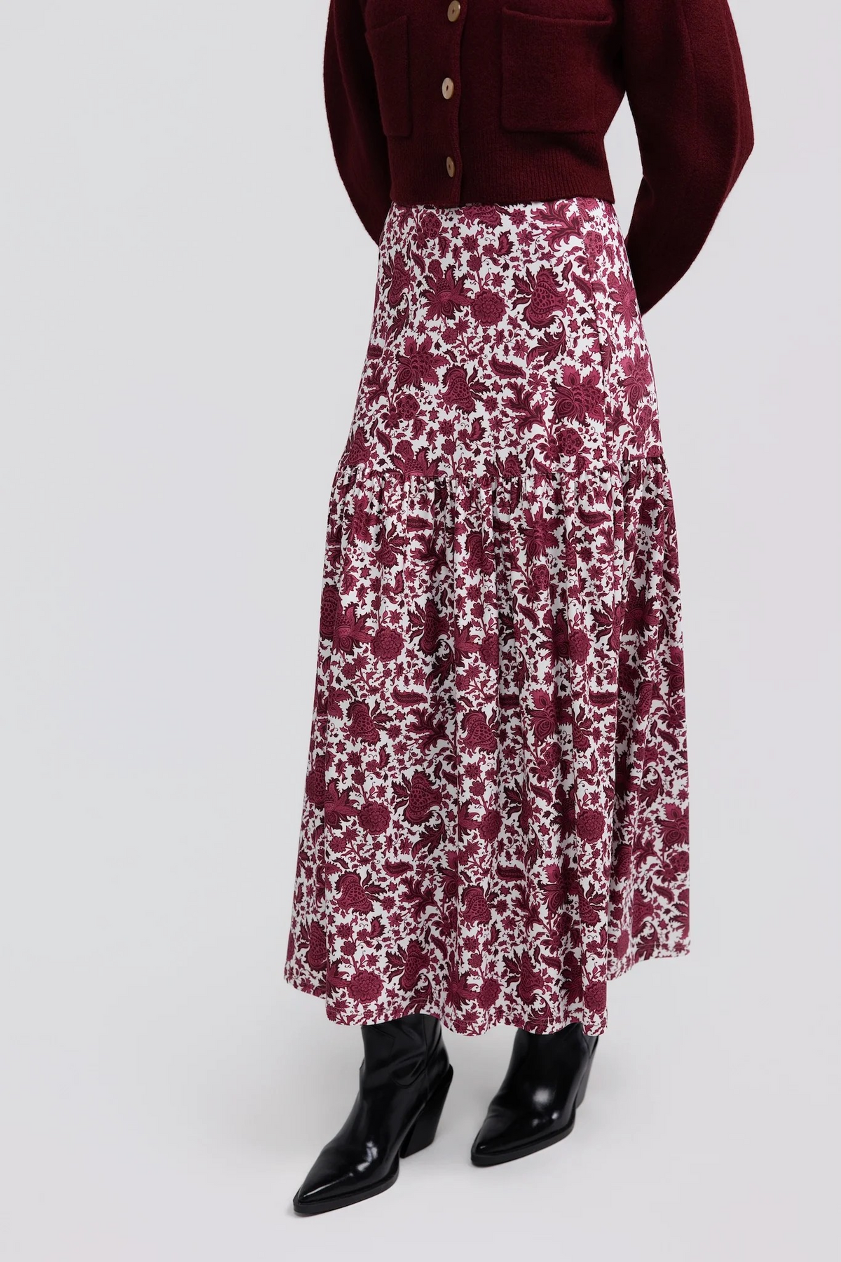 Faye Skirt by Smith & Quinn in raspberry floral print, showing the gathered lower tier and maxi length, angled view