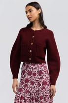 Hildy Sweater by Smith & Quinn in burgundy with contrasting buttons, front patch pockets, and balloon sleeves, front view