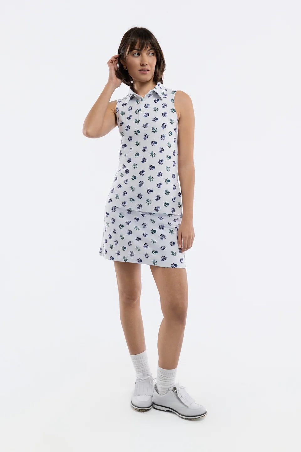 White sleeveless collared top with a navy and green floral print, displayed Style#1207