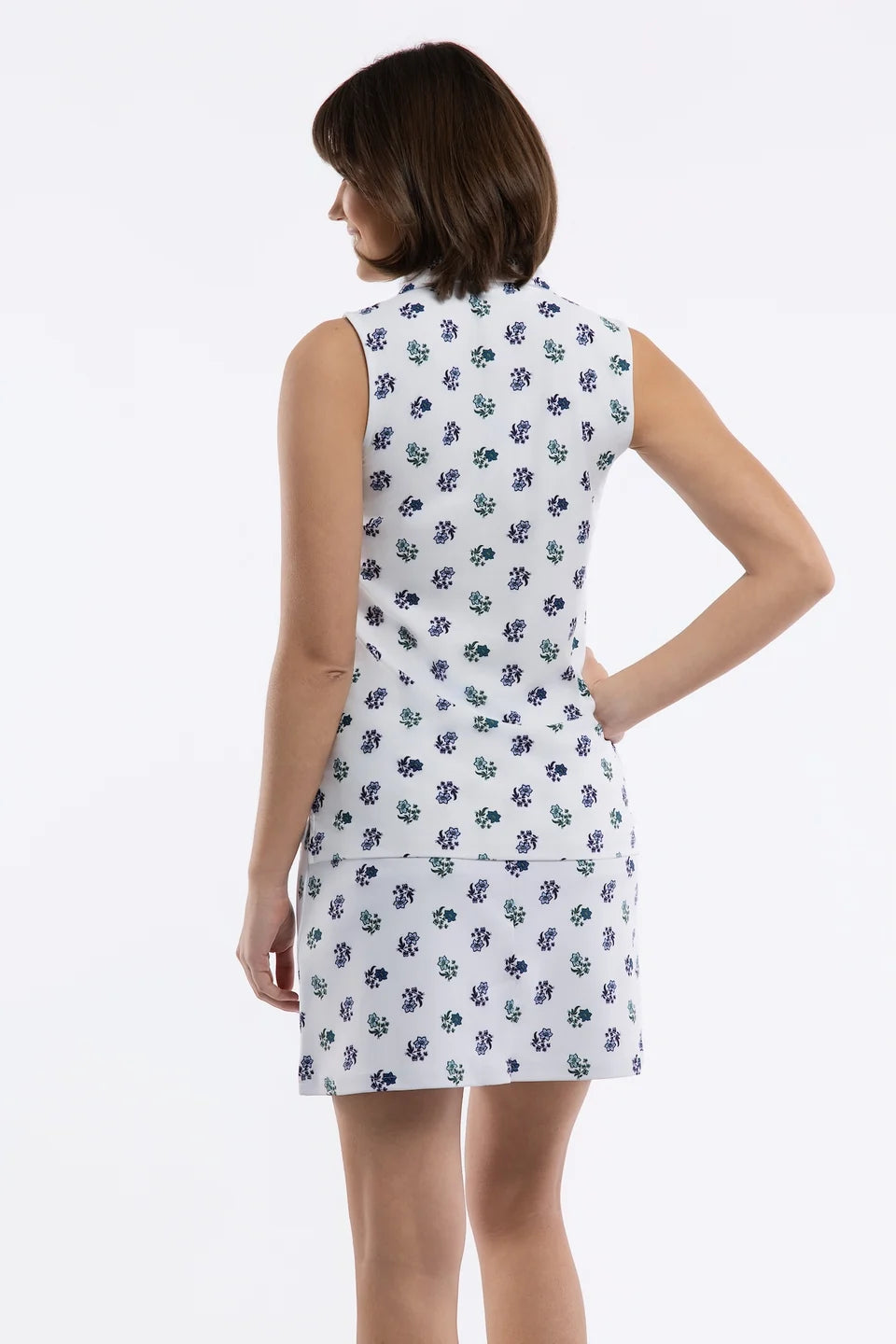 Close-up of a white skirt with a small-scale floral print in navy blue and green, featuring a side pocket.