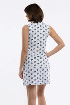 Close-up of a white skirt with a small-scale floral print in navy blue and green, featuring a side pocket.