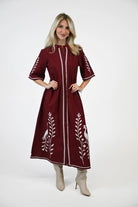 crimson dress white embroidery details