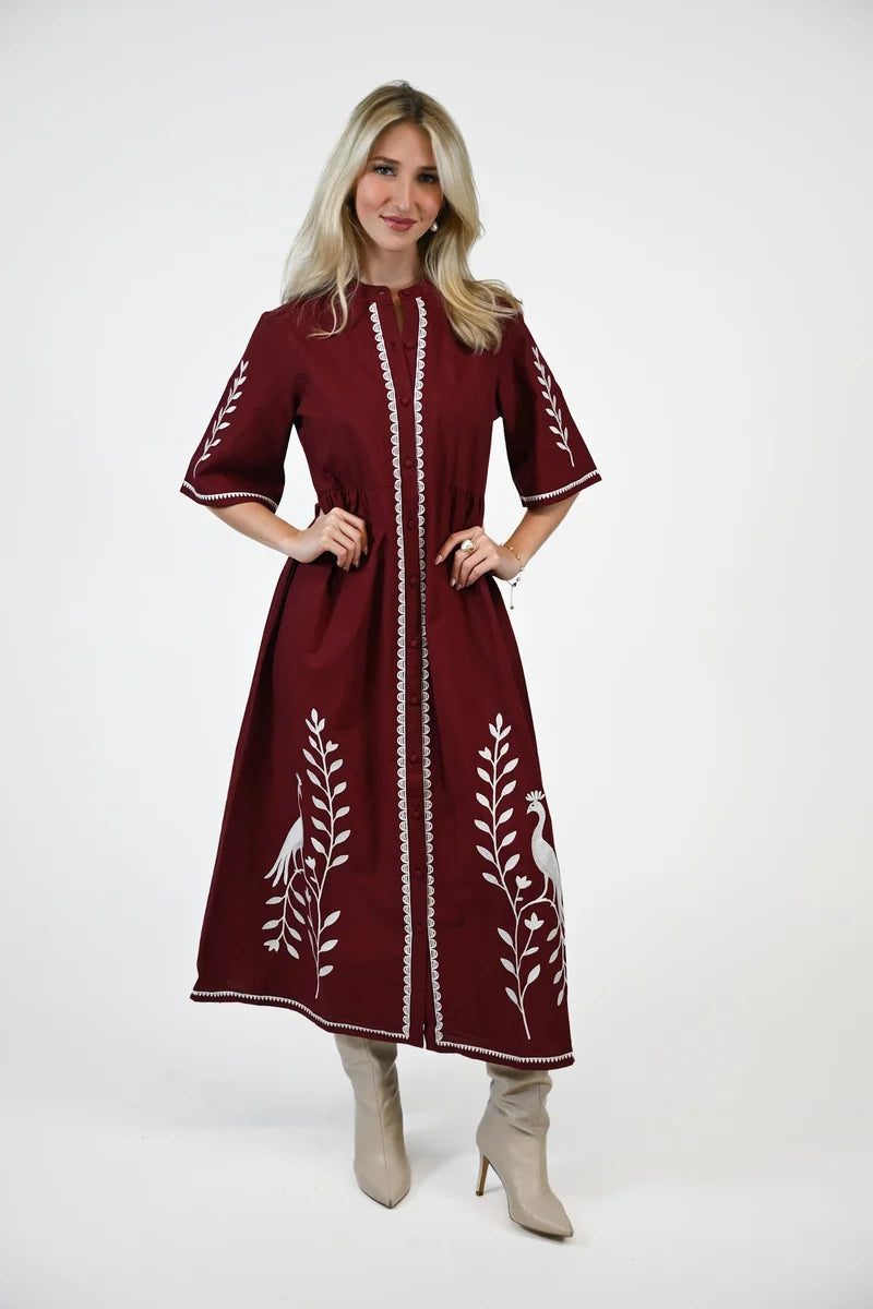crimson dress white embroidery details