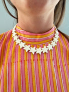  Star Necklace Large Coconut by Smith and Co. Design — cream star bead necklace worn on model
