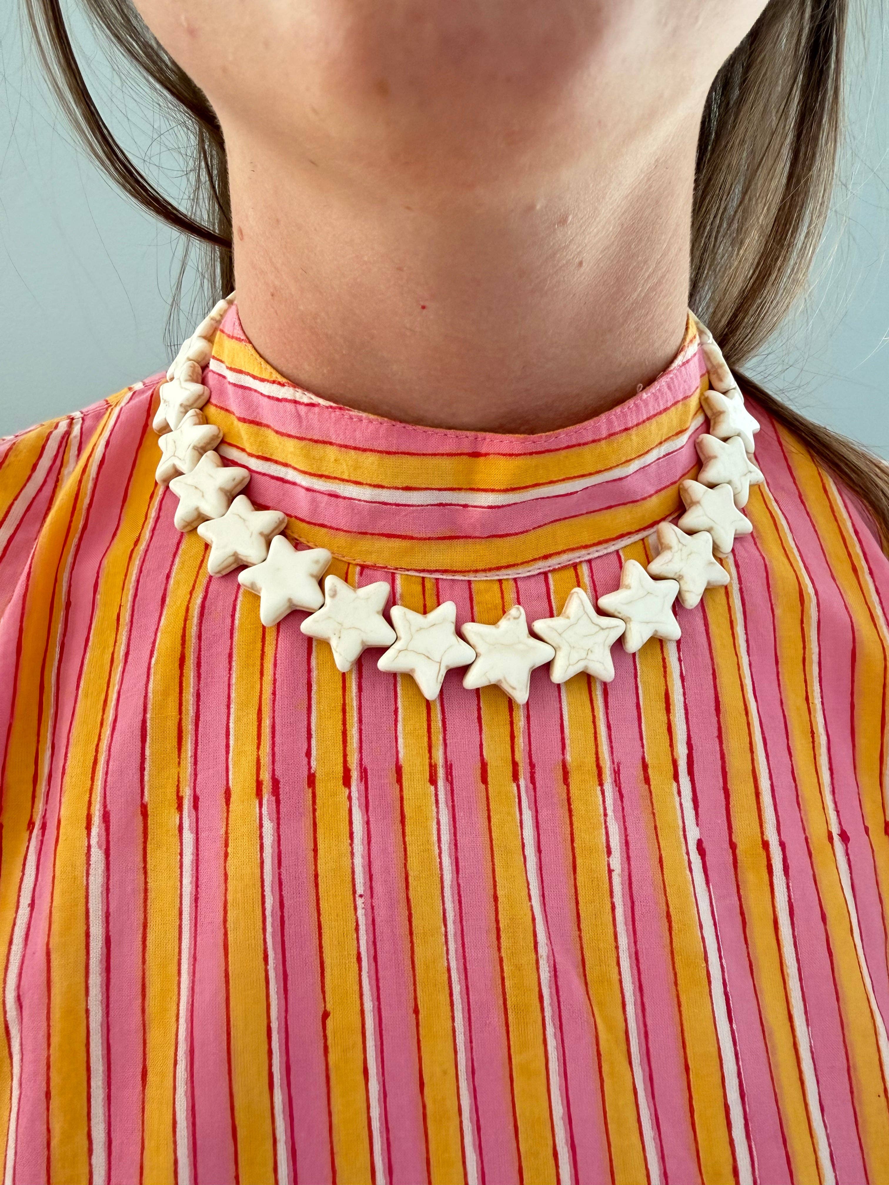  Star Necklace Large Coconut by Smith and Co. Design — cream star bead necklace worn on model

