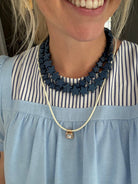 Star Necklace Large Navy by Smith and Co. Design — navy star bead necklace layered on model