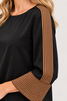 Back view of black Keely Top by THML showing keyhole closure and brown and khaki sleeve stripes, Style #WCT4031