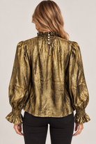 Maren Top by THML in olive-and-gold abstract print with back neckline buttons, long sleeves, and ruffled cuffs, back view.