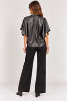 Back view of black Veronica Top showing its silhouette and flowy sleeves, Style #WCT4008-1