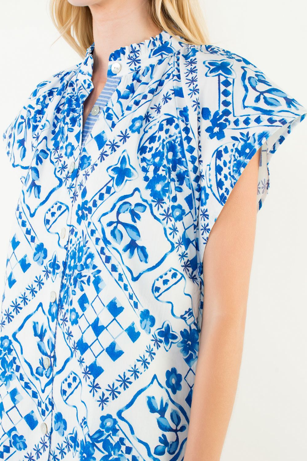 Suzie Dress by THML — close-up of split V-neck, button placket with striped lining, ruffle collar, cobalt blue tile print detail