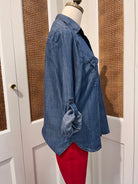 Talma Top by Velvet Heart — side view of medium wash denim button-front shirt with rolled tab sleeves and shirttail hem