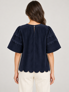 Greer Top by Voy in navy corduroy with bubble sleeves, scalloped trim and a scalloped hem