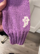 Wooden Ships Mini Ghost Sweater in purple, style K57CE2W739 — close-up of knit ghost motif on ribbed cuff and sleeve
