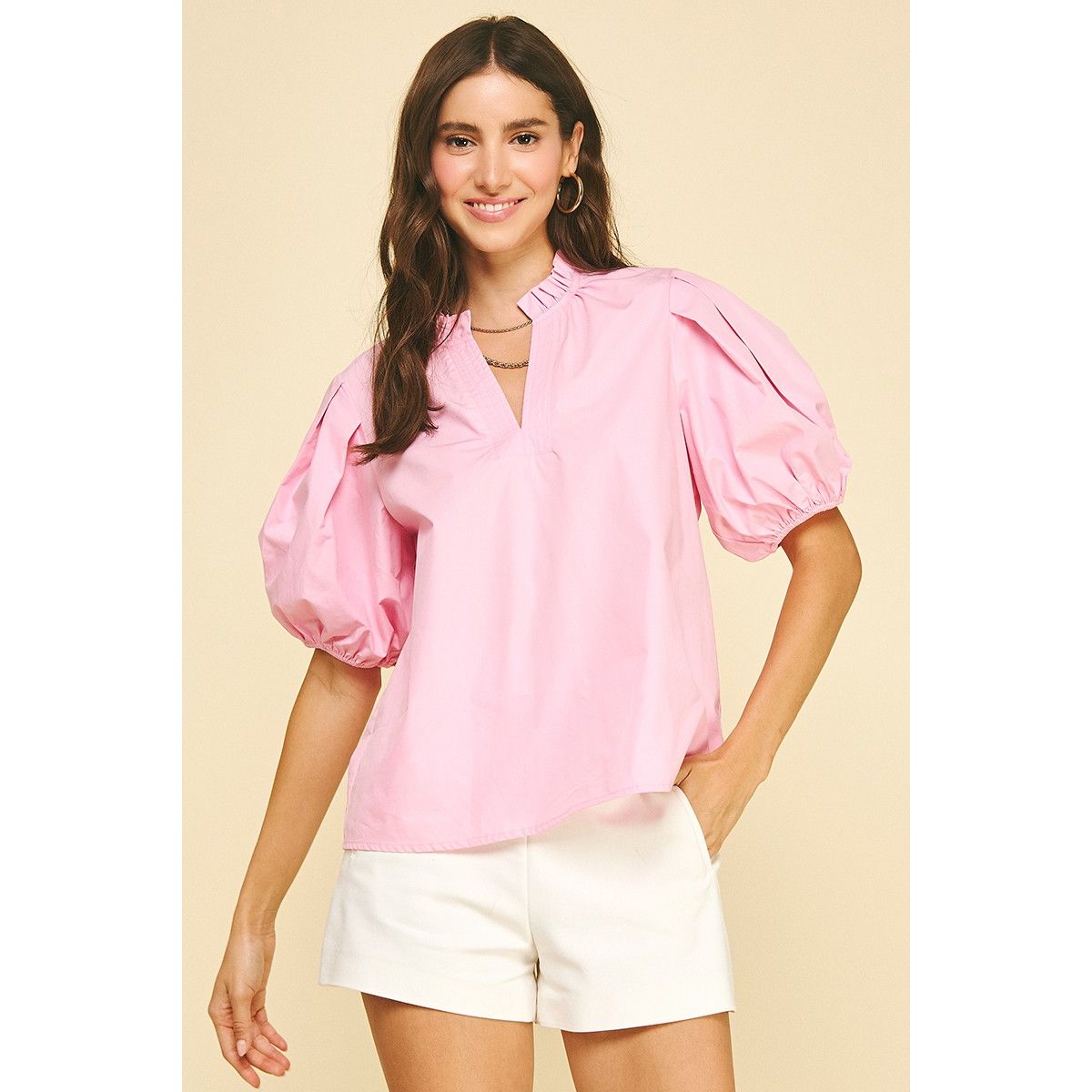 Pink Denise top by Pinch featuring a V-neck and woven fabric, shown in a close-up of the blooming pink design.