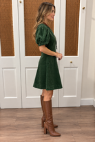 Millie Dress by Entro — forest green corduroy mini dress with zip-front V-neckline, puff sleeves, and A-line skirt, side view Style #D32169
