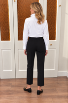 Traveling Pant Black by Duffield Lane with a flat waistband, side pockets, and straight ankle-length legs, back view