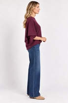 Eloise Top by Entro in merlot, side view showing round neckline, center seam, and wide draped sleeves. D31013