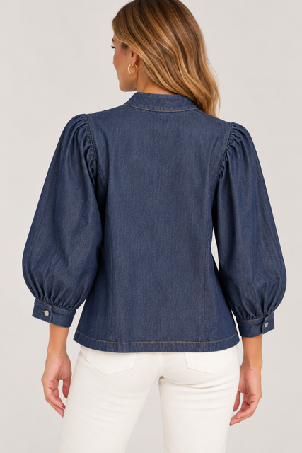 Lucy Top by Entro in dark denim with an off-center bow closure, band collar, and puffed sleeves, back view
