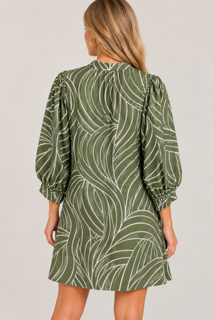 Susan Dress by Entro in olive with a curved cream motif, split V neckline, and smocked cuffs, front view