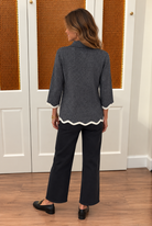 Bennett Sweater by Fate in charcoal shimmer knit with a mock neck and ivory-trimmed scalloped cuffs and hem, back view