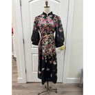 Black floral JADE Nora dress with a fitted bodice and flowing skirt, perfect for casual or semi-formal occasions.