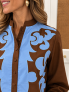 Daphne Top by Jodifl — chocolate brown button-front top with periwinkle blue appliqué scrollwork, zoom 1 view