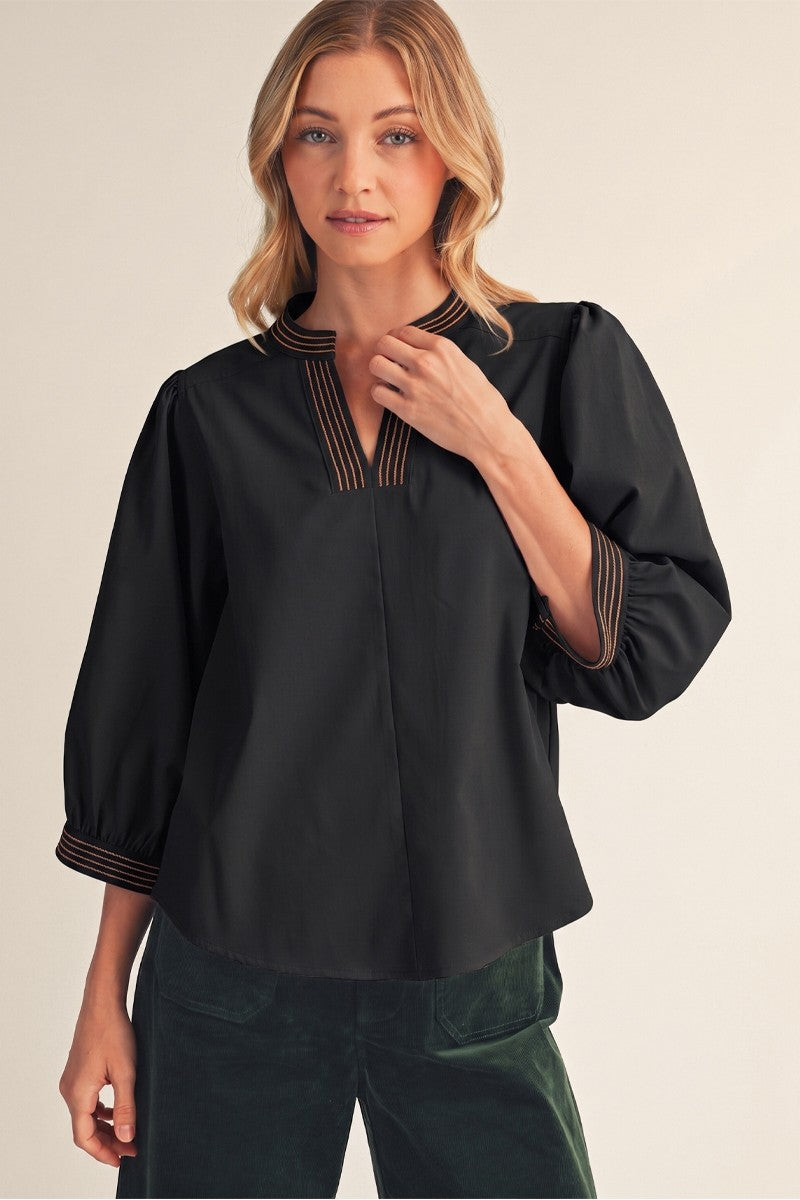 Nell Top by Jodifl in black, front view showing contrast-stitched split neckline and cuffs G16104