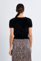 Martha Top by Molly Bracken in Black, back view, fitted eyelash knit sweater, crew neckline with frayed edge trim, short cap sleeves with frayed edges, cropped waist length Style # NL45EN