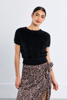 Martha Top by Molly Bracken in Black, front view, fitted eyelash knit sweater, crew neckline with frayed edge trim, short cap sleeves with frayed edges, cropped waist length Style # NL45EN
