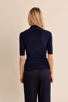 Mary Lou Top by Molly Bracken in Navy, back view, fitted ribbed knit mock turtleneck, elbow-length sleeves, gold button shoulder detail, slim silhouette Style# LA2012EN