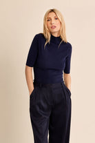 Mary Lou Top by Molly Bracken in Navy, front view, fitted ribbed knit mock turtleneck, elbow-length sleeves, gold button shoulder detail, slim silhouette Style# LA2012EN